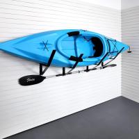 Wall-mounted slatwall bracket holding a kayak in a garage storage system.