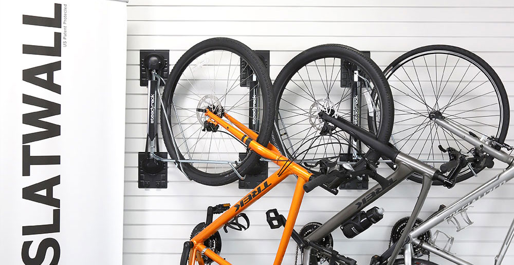 Organized garage with MKE Slatwall panels displaying various sports equipment.
