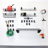 Slat wall hooks for lawn and garden tools in an organized garage.