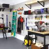 Close-up of tools organized on MKE Slatwall panels in a garage workshop.