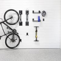 Slatwall-mounted hooks and baskets holding bike helmets and accessories